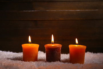 Obraz na płótnie Canvas Burning candles on wooden background