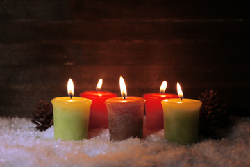 Burning candles on wooden background