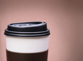 Paper Cup of Coffee on brown background. Takeaway or Disposable