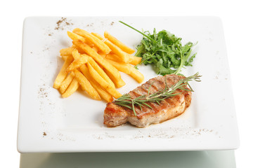 Steak with potato and vegetable garnish