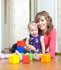  mother and baby plays with toys