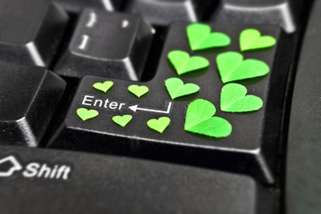 computer keyboard covered with green heart shape leaves