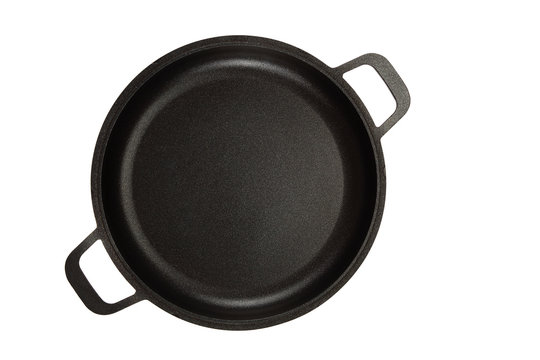 Black cast-iron frying pan on white background.