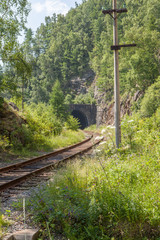 The railway tunnel in a rock on the bank of lake Baikal.