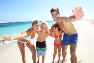 Family of four having fun at the beach