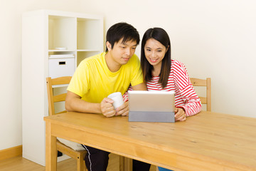 Asian couple using tablet together