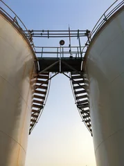 Fotobehang ladder and storage tank © nopparatk