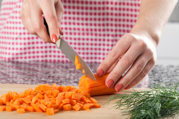 Woman chopping carrot