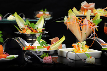 Various festive gourmet dishes on black background