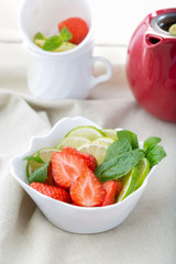 Freshly sliced strawberries, lime and mint