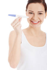 Happy smiling woman with pregnancy test.