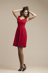 Fashion photo of young  woman in red dress.