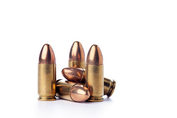 A group of 9mm bullets for a a gun isolated on white - obrazy, fototapety, plakaty