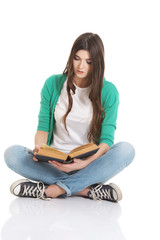 Young beautiful student sitting with book, reading, learning.