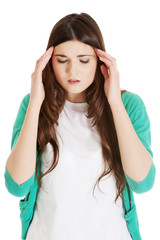 Young casual woman is having headache.