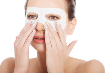 Young beautiful woman with collagen eye mask.