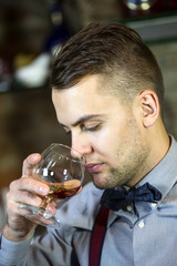 young man working as a bartender in a nightclub bar