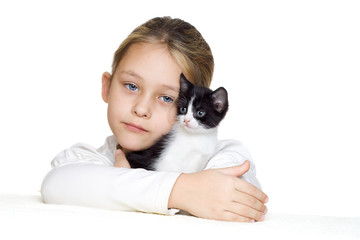 little girl tenderly embraces a kitten