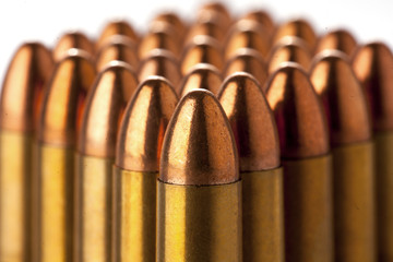 A group of 9mm bullets for a a gun isolated on white