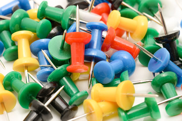 Colorful push pins on white background