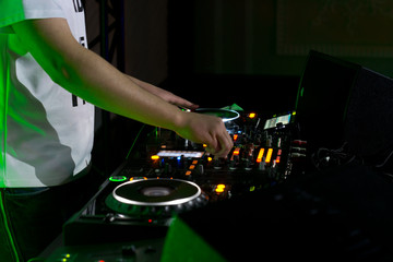 Disc jockey mixing and blending music tracks