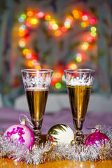 Goblets with sparkling wine and festive toys amid colorful heart
