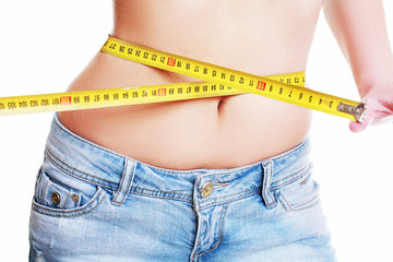 female measuring her waist