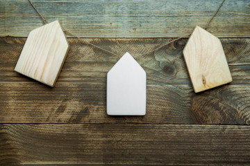 house shaped decoration hanging on the old wood background.