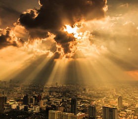 Rays of light shining through dark clouds in Bangkok, Thailand