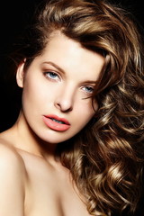 beautiful sexy brunette with bright makeup,curly healty hair