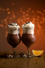 Tasty dessert with chocolate, cream and orange sauce,
