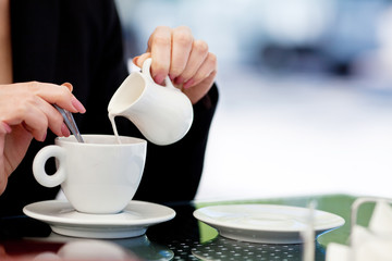 portrait of a young woman in a cafe with a laptop