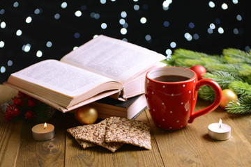 Composition of book with cup of coffee and Christmas