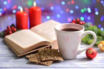 Composition of book with cup of coffee and Christmas