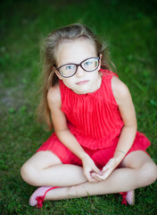 Sweet little girl in summer day wearing glasses