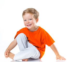 Happy boy sitting on the floor