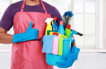 Portrait of young man with cleaning equipment