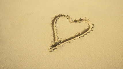 Love sign written on sand
