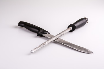 Knife and whetstone isolated on white background