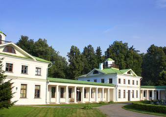 White old time buildings on the background of trees