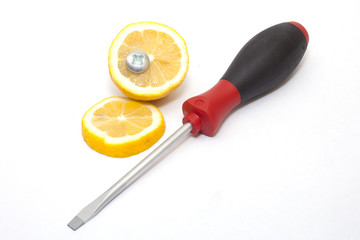 screwdriver, bolt and lemon on white background