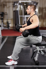 Athletic man working with heavy dumbbells