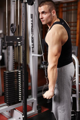 Athletic man pulling heavy weights