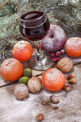 wine glass with fruit cake, nuts and fruits
