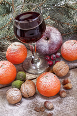 wine glass with fruit cake, nuts and fruits