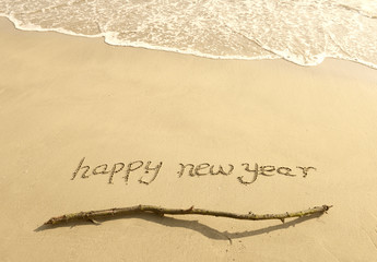 happy new year message on the sand beach