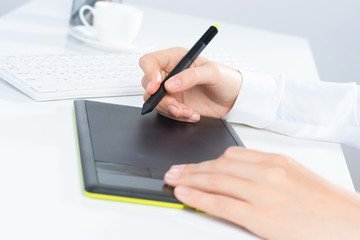 Designer hand drawing a graph on the tablet