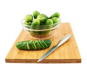 Slicing cucumber over a cutting board