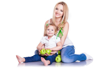 portrait of young mother and little daughter with apples