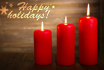 Burning candles on wooden background